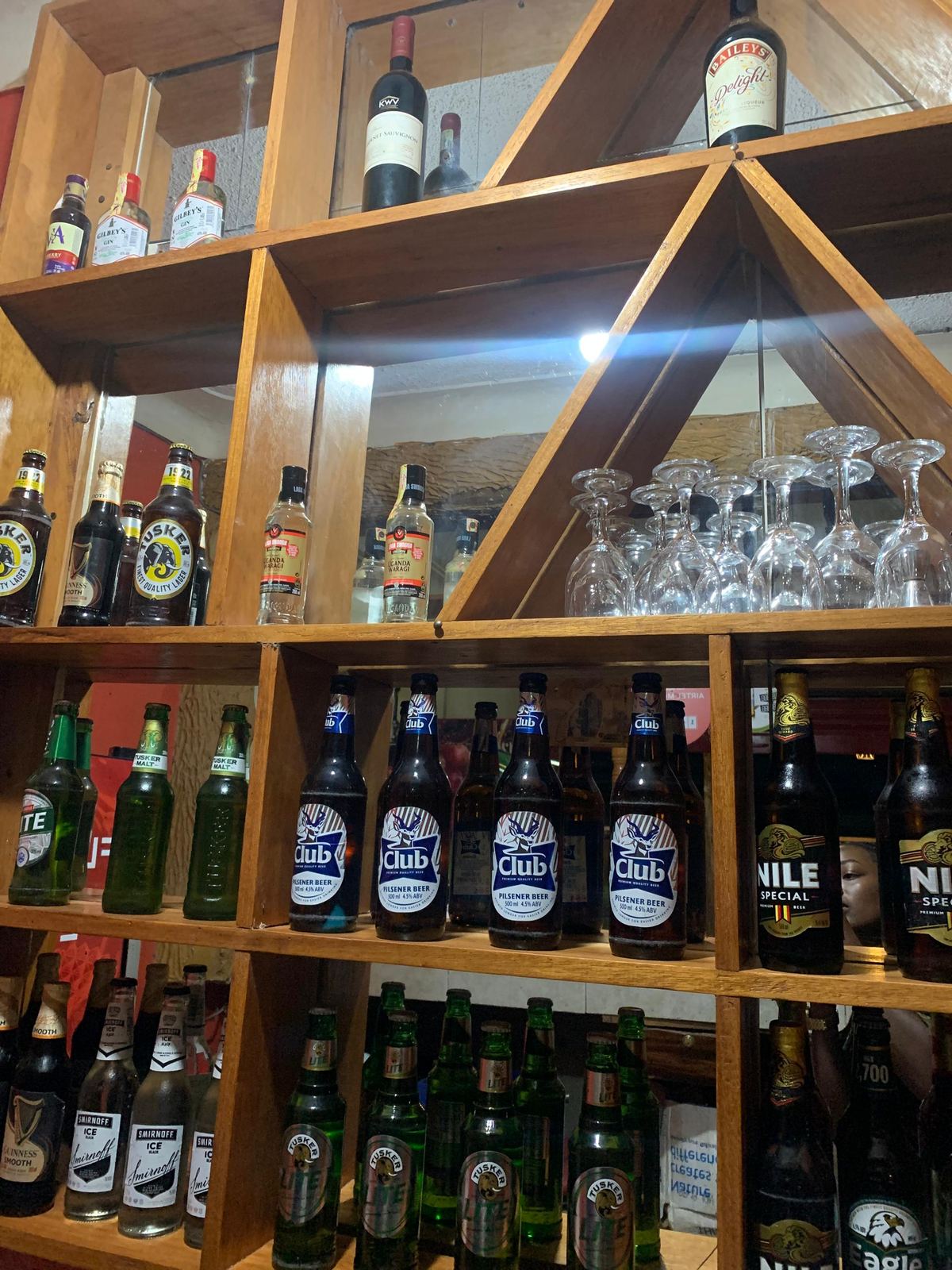 Hotel bar shelves stocked with bottles and glasses